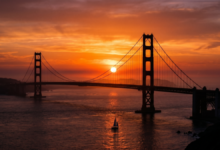 The Golden Gate Bridge with the sun setting the background.